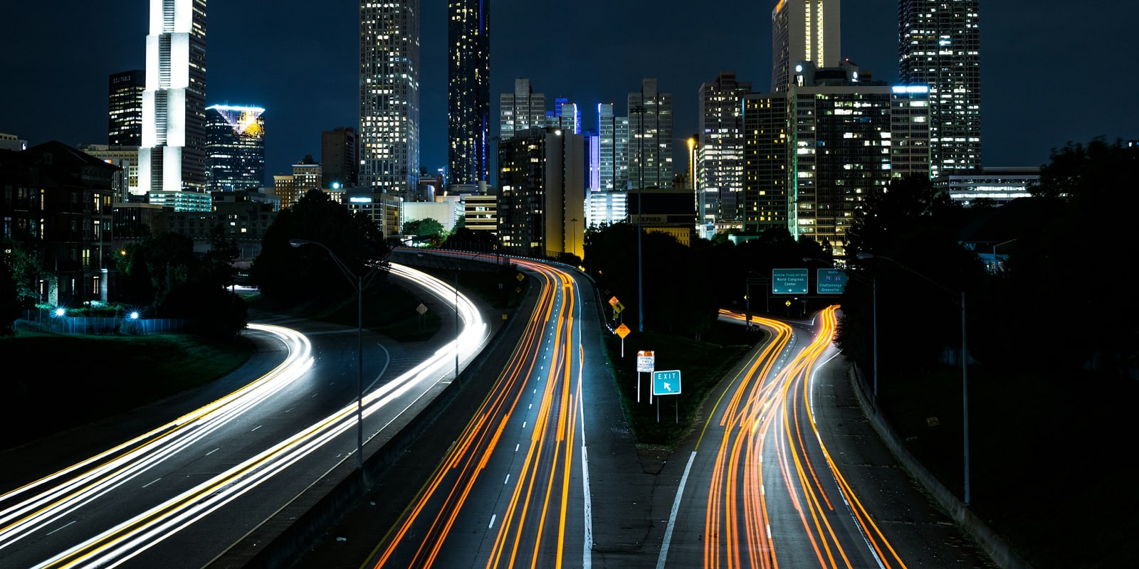 City financial district at night with traffic light trails